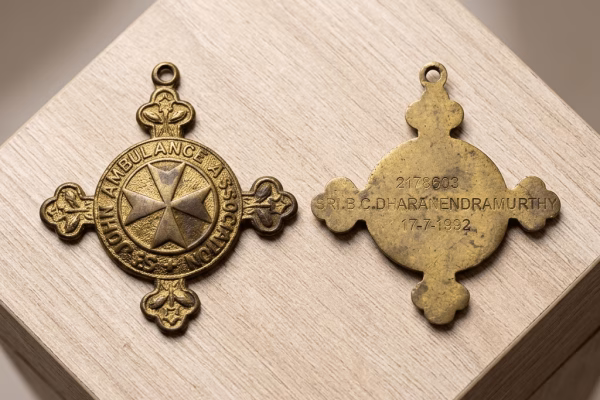 Front and back of St. John Ambulance Brigade Gold Medal awarded in Bengaluru on July 17, 1992, showing Maltese cross emblem and engraved serial number 2178603.
